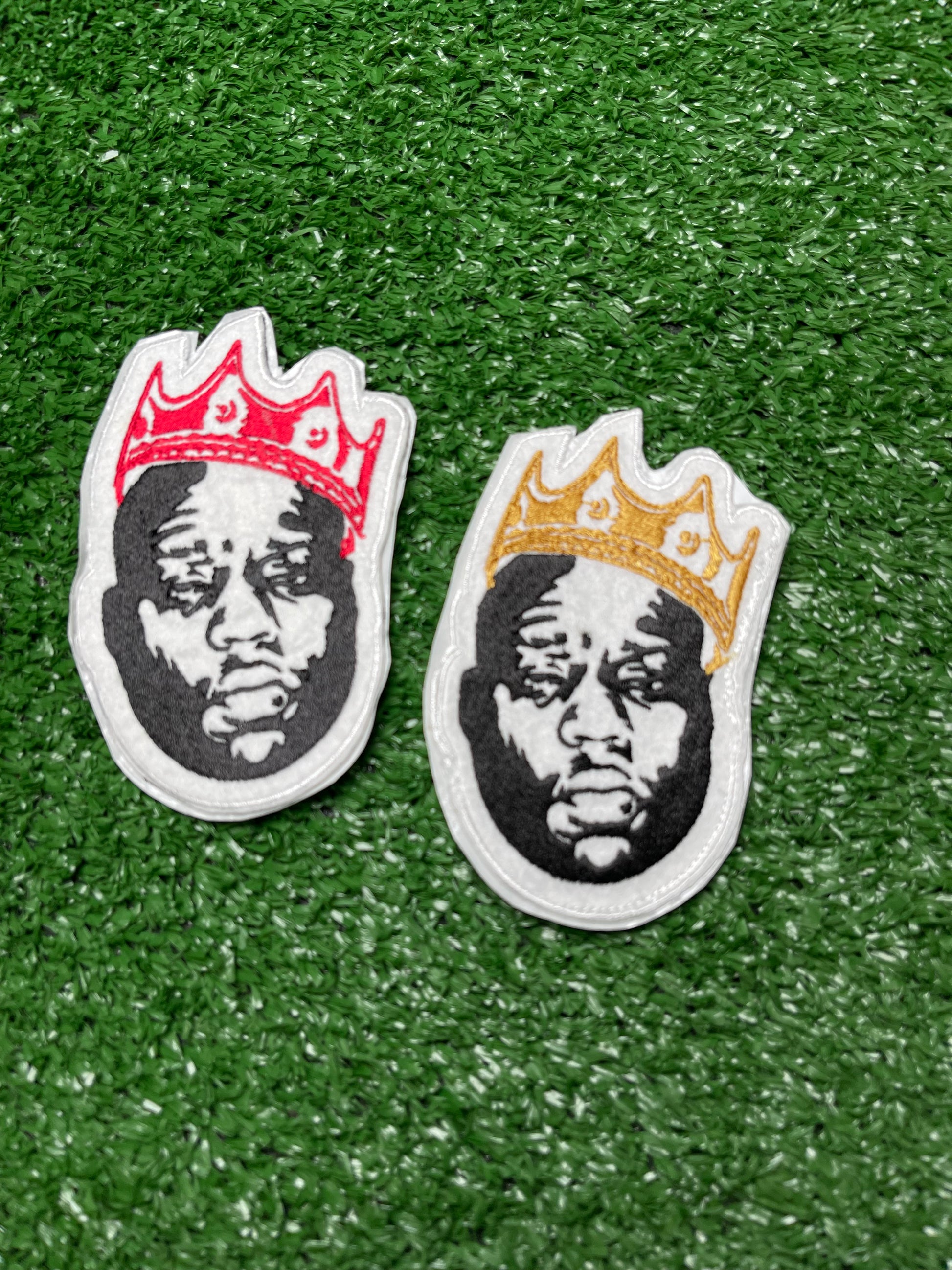 Custom embroidered patch of the Notorious BIG wearing a red crown stitched in black, white, and red thread. Custom embroidered patch of the Notorious BIG wearing a gold crown stitched in black, white, and red thread.