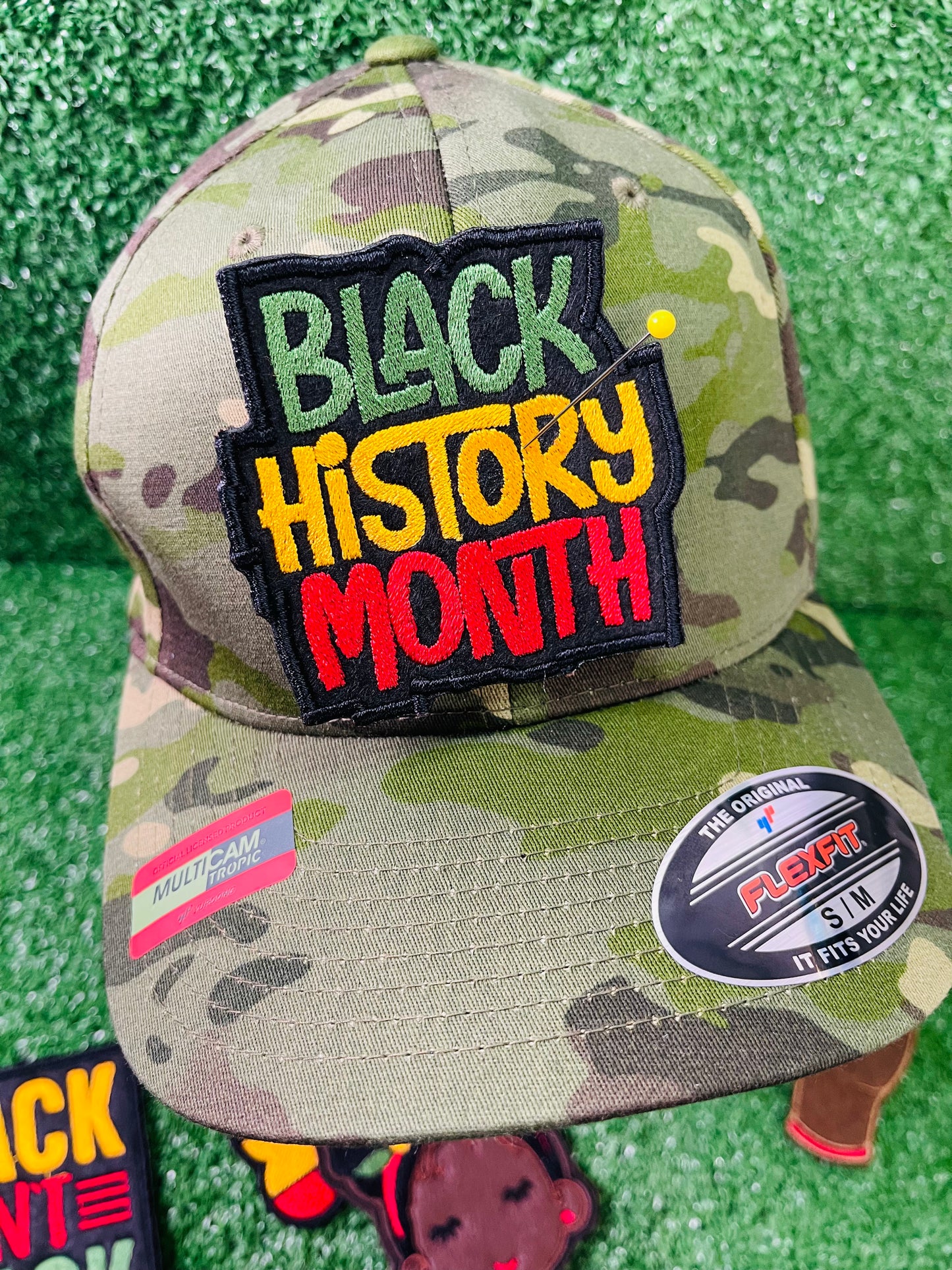 An image of custom Black History Month patches featuring vibrant, bold designs that celebrate Black culture, heritage, and achievements. The patches include empowering phrases, colorful Afrocentric patterns, and symbols of unity and pride. Each patch is intricately embroidered, showcasing high-quality craftsmanship and thoughtful design, perfect for honoring Black History Month on clothing, bags, or accessories.
