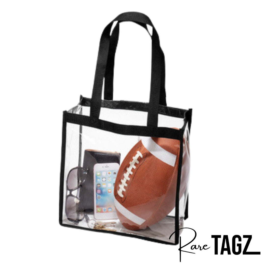 Transparent clear tote bag with black trim and long handles, suitable for stadium and event use. Clear Bags, Stadium Approved, Clear Tote Bags, Football Games, Concert Venues