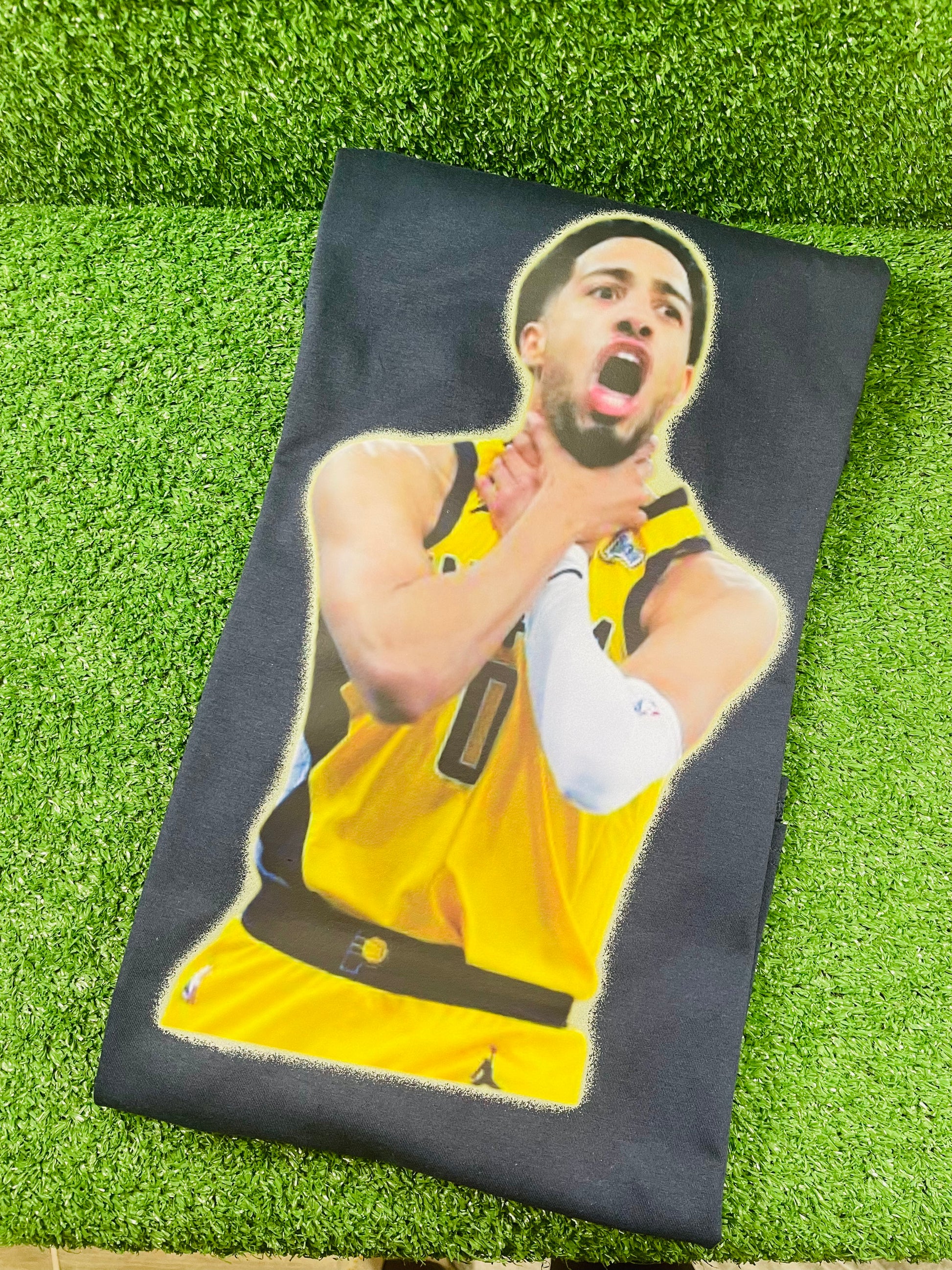 Tyrese Haliburton in a yellow Pacer jersey mid celebration, gripping his neck with both hands in a passionate playoff moment, against a blurred arena crowd.