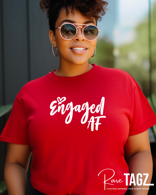 Woman wearing a red Engaged AF t-shirt with white lettering, styled by Rare Tagz. Bachelorette t-shirt, bride-to-be t-shirt, bachelorette, bridal shower, fiance, wedding, wedding gifts