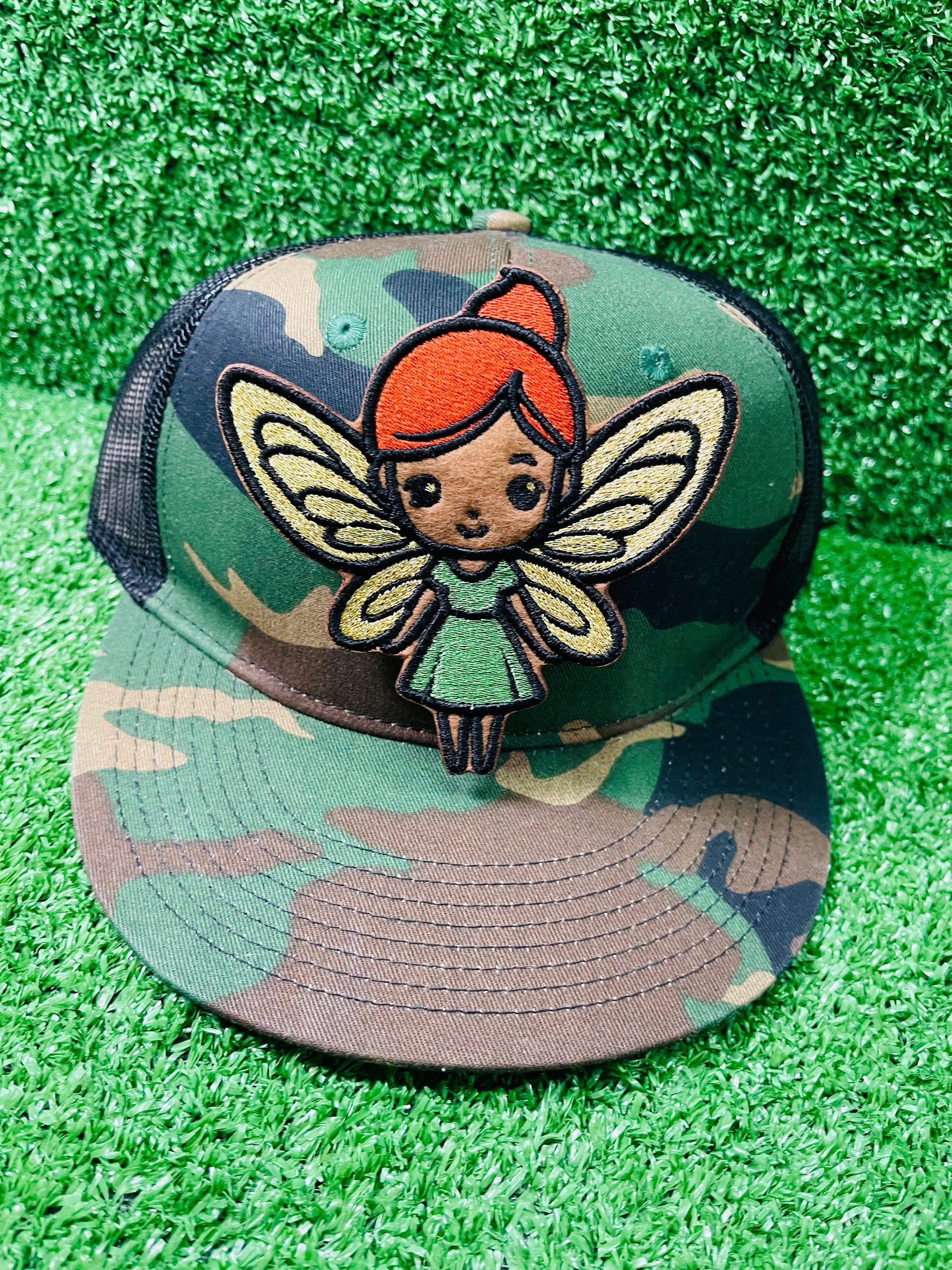 Custom embroidered iron-on patch of a brown skinned fairy with burnt orange hair, gold wings and a green dress inspired by the viral she was a fairy Tiktok sound.