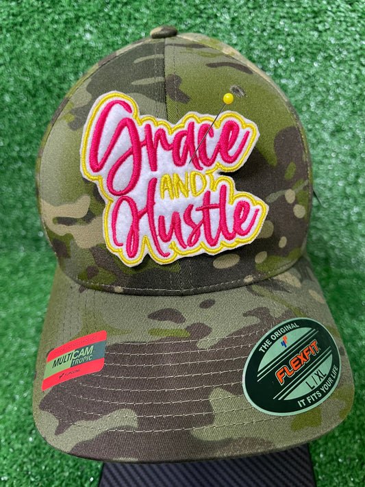 Grace and Hustle embroidered iron-on patch in bold pin k and yellow thread with white background. Motivational iron-on patch for jackets, bags, and custom appearel.