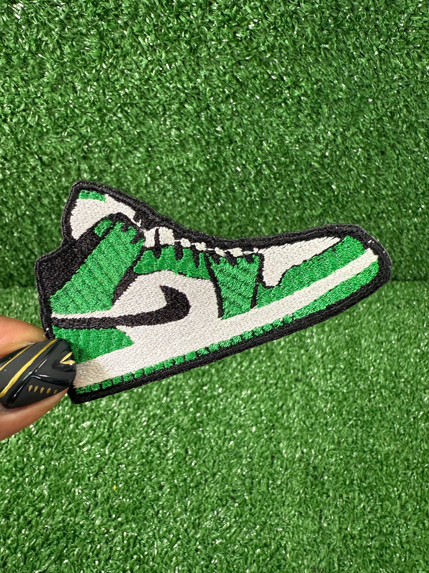 Embroidered iron on patch of a green and white nike style air Jordan sneaker with black accents designed by Rare Tagz.
Perfect for streetwear, sneakerheads, and DIY jackets or bag designs.