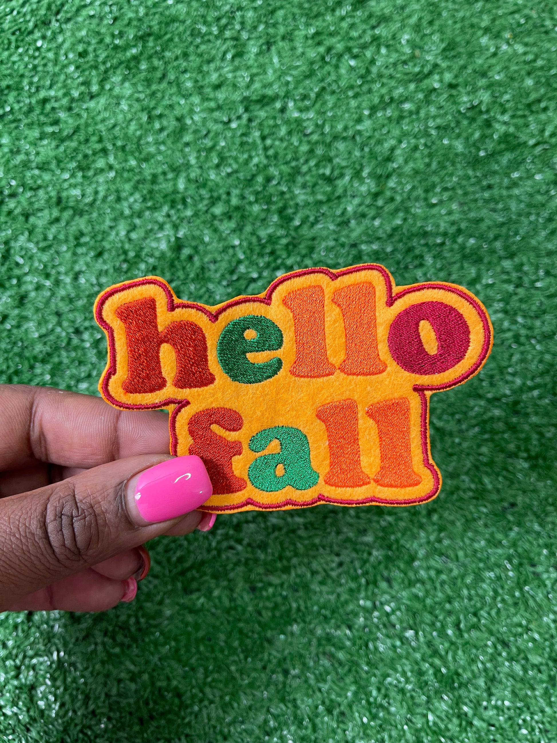A Hello Fall iron-on patch with warm autumn colors featuring a cozy and welcome design perfect for jackets, bags, or trucker hats.