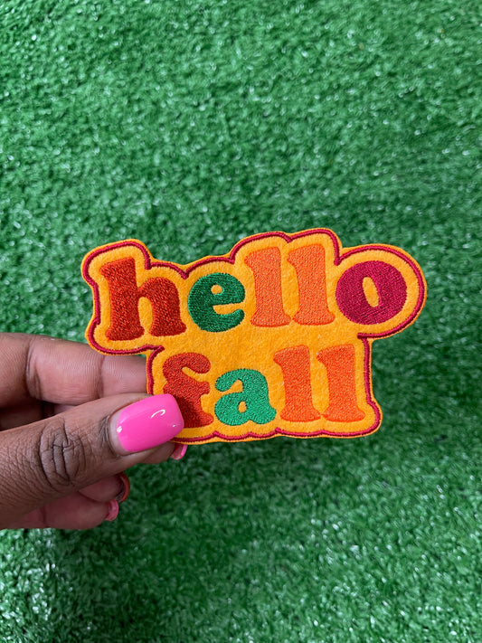 A Hello Fall iron-on patch with warm autumn colors featuring a cozy and welcome design perfect for jackets, bags, or trucker hats.