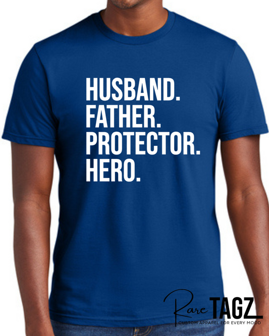 Royal blue t-shirt with bold white text reading Husband Father Protector Hero from Rare Tagz, perfect for Father's Day.