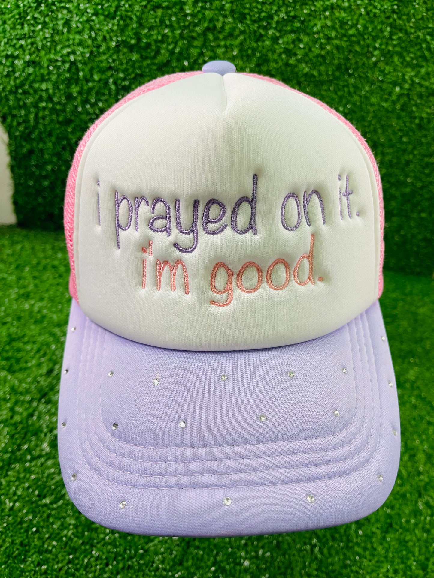 Custom embroidered pink and purple trucker hat with the phrase I prayed on it. I'm good. stitched on the front in purple and pink thread. The lavender brim is embellished with small rhinestones, adding a sparkly touch.