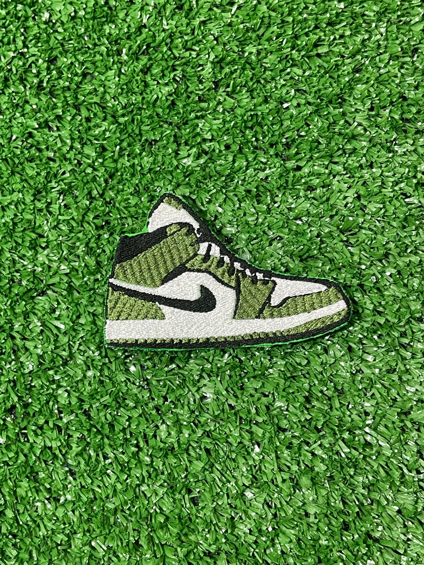 Embroidered iron on patch of a green and white nike style air Jordan sneaker with black accents designed by Rare Tagz.
Perfect for streetwear, sneakerheads, and DIY jackets or bag designs.