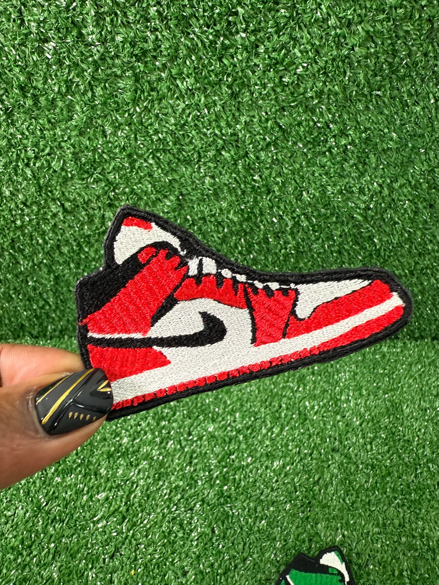 Embroidered iron on patch of a green and white nike style air Jordan sneaker with black accents designed by Rare Tagz.
Perfect for streetwear, sneakerheads, and DIY jackets or bag designs.