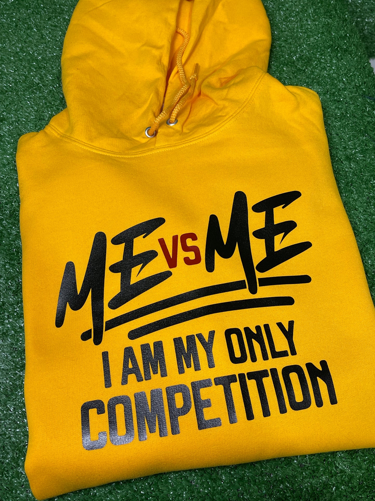 Bold yellow hoodie featuring the empowering phrase “ME vs ME – I Am My Only Competition” in striking black and red lettering. Perfect for those who embrace self-improvement and personal growth. Made from premium fabric for comfort and style.