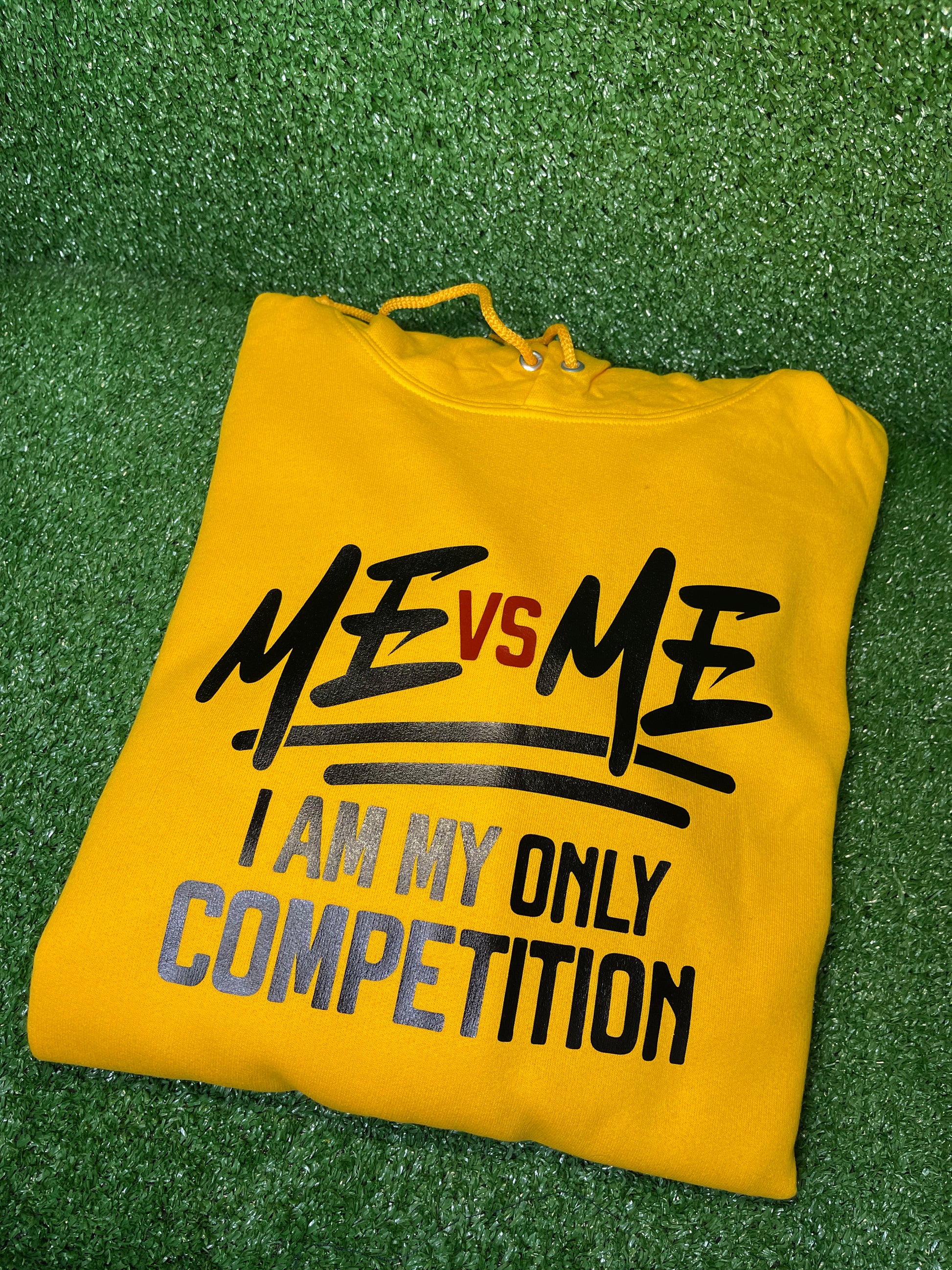 Bold yellow hoodie featuring the empowering phrase “ME vs ME – I Am My Only Competition” in striking black and red lettering. Perfect for those who embrace self-improvement and personal growth. Made from premium fabric for comfort and style.