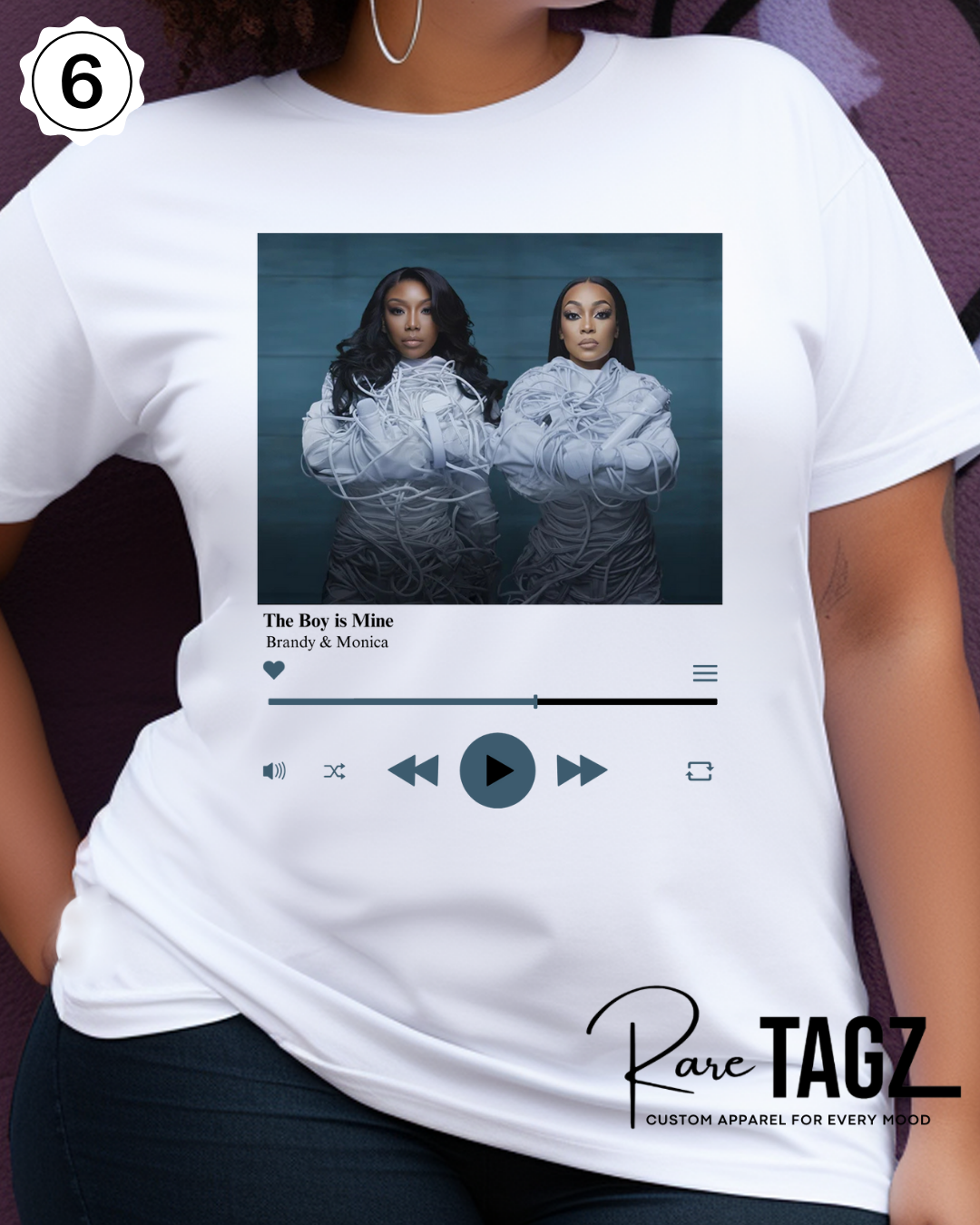 Woman wearing a white t-shirt with graphic design of Brandy and Monica and text that reads The Boy is Mine. Promoting the Boy is Mine Tour.