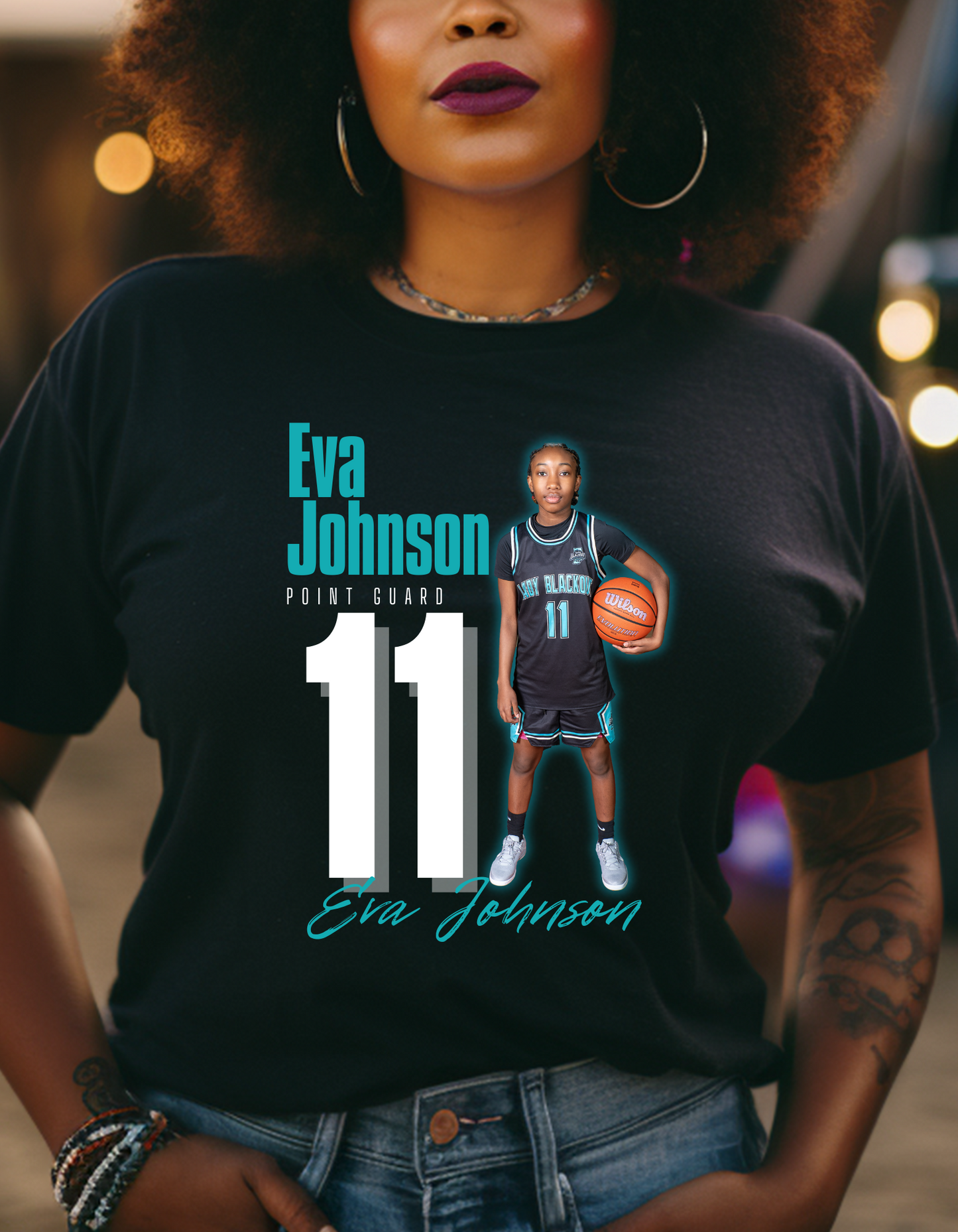Custom black basketball shirt featuring a young female athlete in uniform holding a basketball with her name Eva Johnson position, and jersey humber printed in bold graphic text.