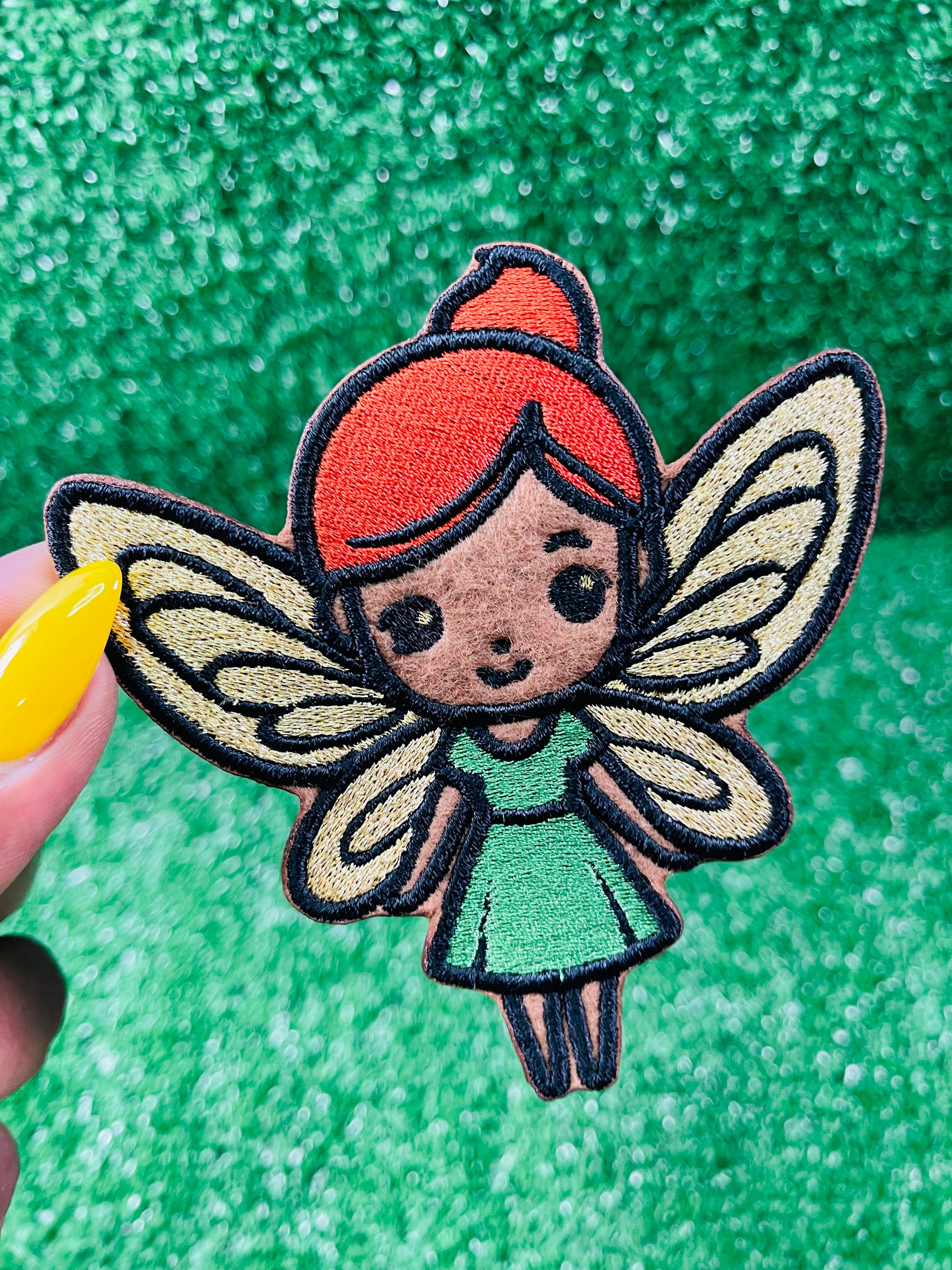 Custom embroidered iron-on patch of a brown skinned fairy with burnt orange hair, gold wings and a green dress inspired by the viral she was a fairy Tiktok sound.