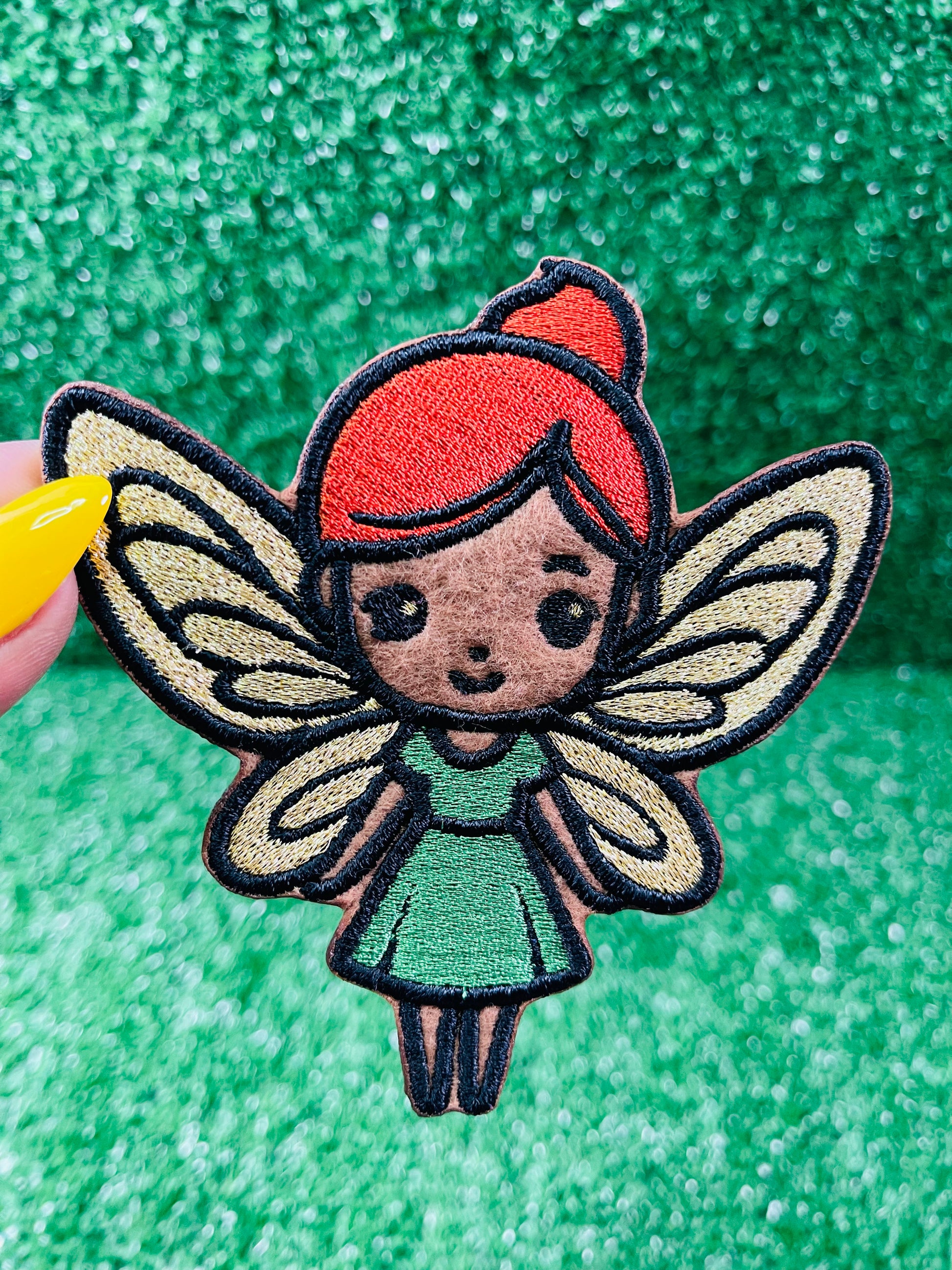 Custom embroidered iron-on patch of a brown skinned fairy with burnt orange hair, gold wings and a green dress inspired by the viral she was a fairy Tiktok sound.
