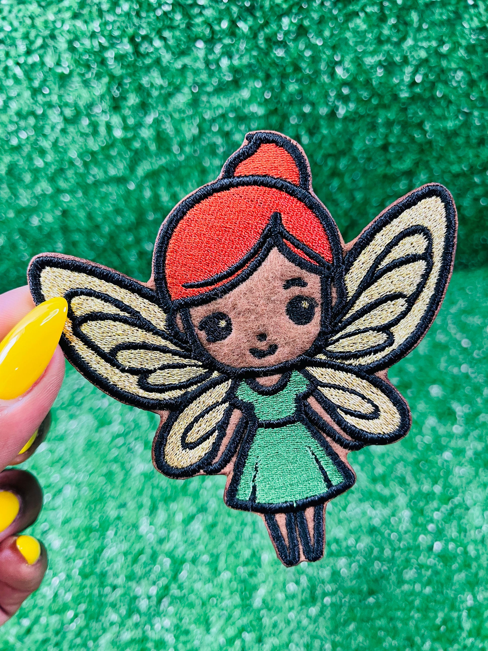 Custom embroidered iron-on patch of a brown skinned fairy with burnt orange hair, gold wings and a green dress inspired by the viral she was a fairy Tiktok sound.