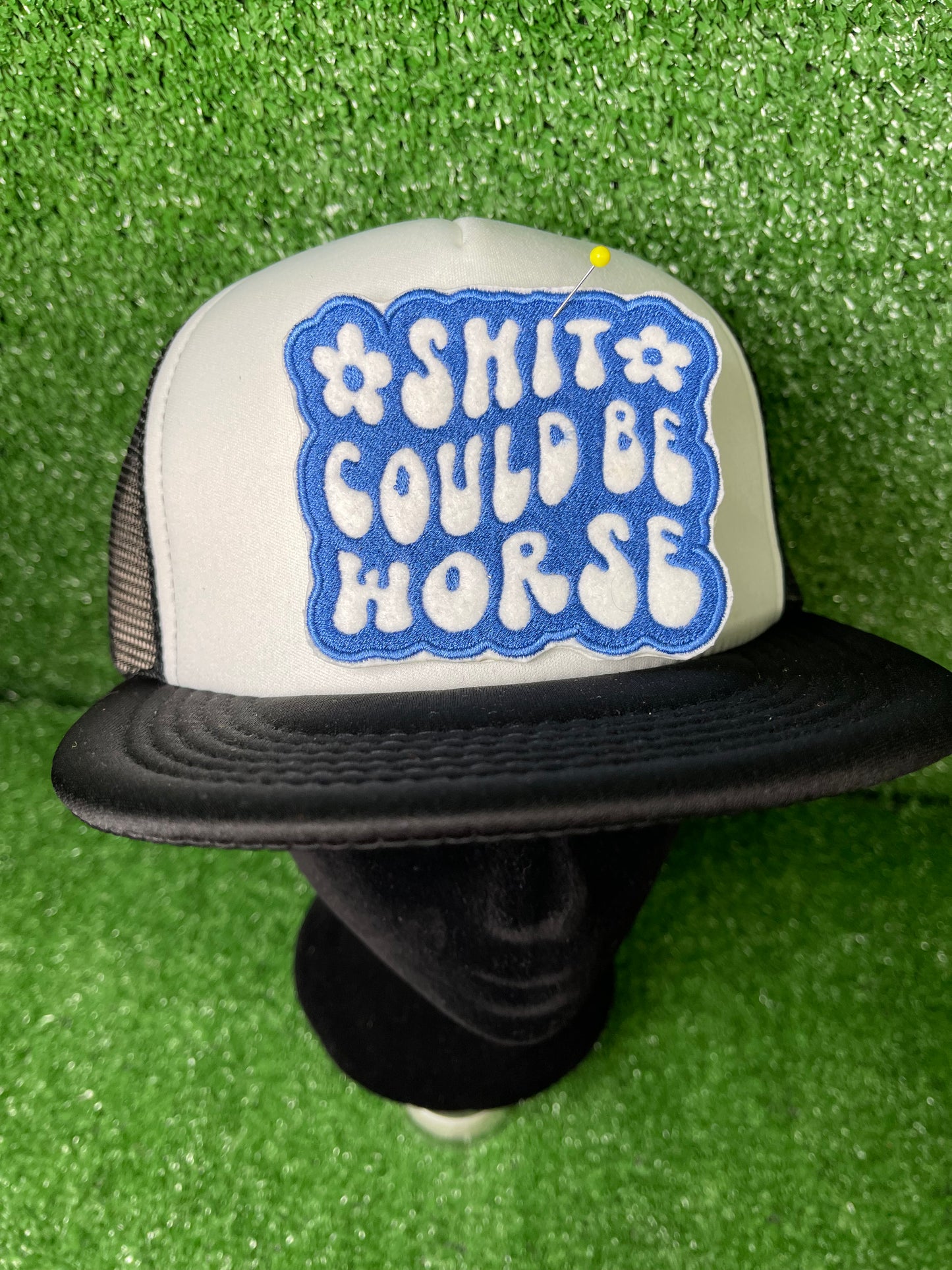 Embroidered patch with the phrase Shit Could be Worse in bold white lettering on a blue background. The design is simple yet impactful, adding a touch of humor and resilience to any jacket, backpack or trucker hat.