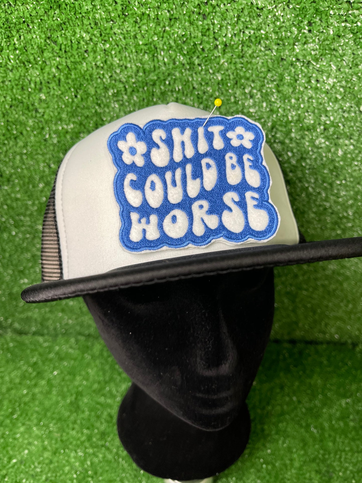 Embroidered patch with the phrase Shit Could be Worse in bold white lettering on a blue background. The design is simple yet impactful, adding a touch of humor and resilience to any jacket, backpack or trucker hat.