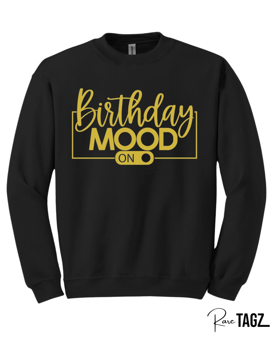 bold black crewneck sweatshirt featuring the phrase Birthday Mood On in stylish gold lettering with an on-switch graphic. This cozy and festive birthday sweatshirt by Rare Tagz is perfect for birthday celebrations, photo ops, and turning up your birthday energy in style.