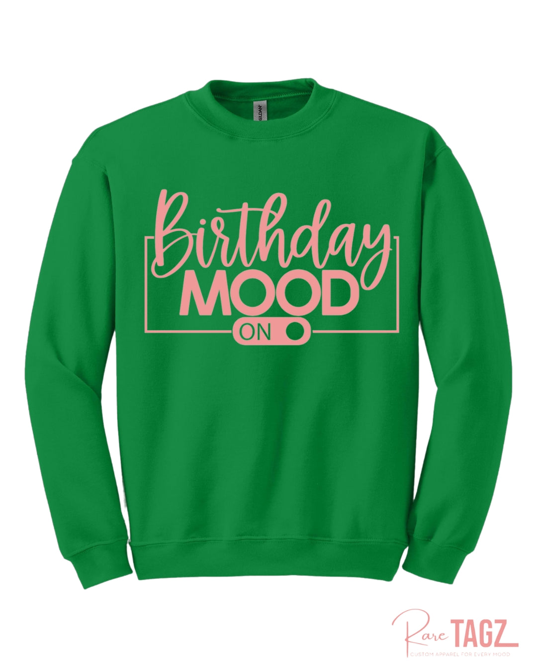 Green crewneck sweatshirt featuring the phrase Birthday Mood On in stylish pink lettering with an on-switch graphic. This cozy and festive birthday sweatshirt by Rare Tagz is perfect for birthday celebrations, photo ops, and turning up your birthday energy in style.