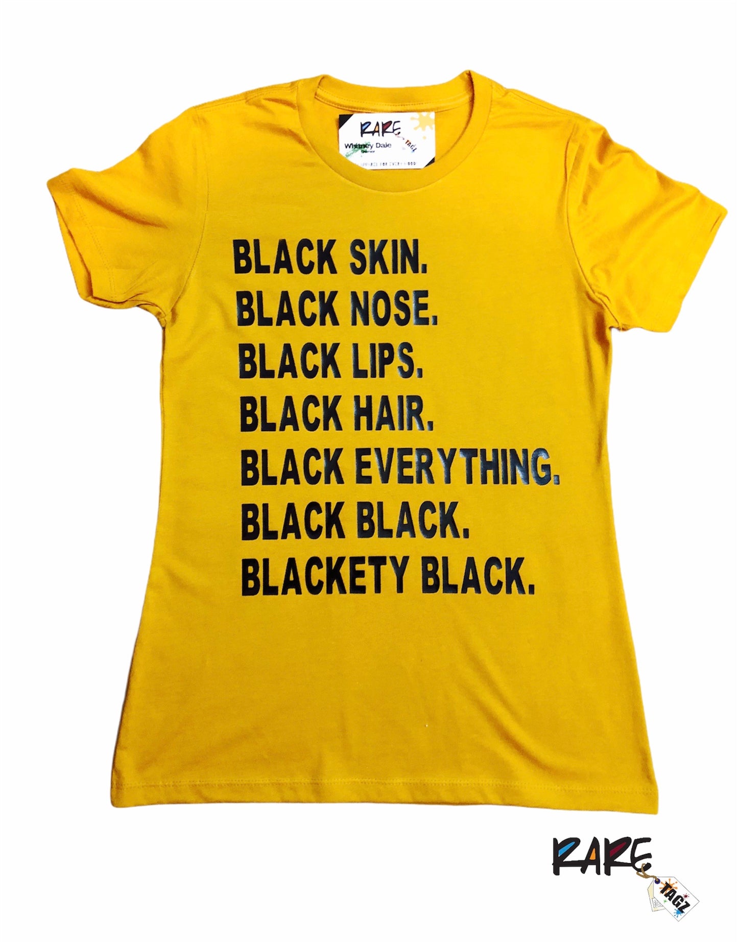 Gold t-shirt with bold black text that reads Black Skin Black Nose Black Lips Black Hair Black Everything Black Black Blackety Black Designed By Rare Tagz