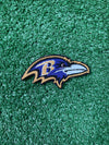 Detailed view of a Baltimore Ravens patch showcasing the team's raven head logo with striking colors, perfect for customizing jackets, trucker hats, or bags with team pride.