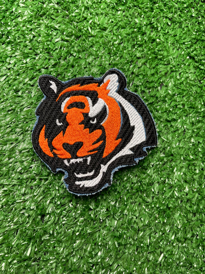 Embroidered Bengal Tiger iron-on patch featuring a detailed and vibrant design of a majestic Bengal Tigers face. Perfect for jackets, backpacks, hats, and clothing. Embroidered iron-on patch featuring the Bengals logo with bold colors and stitching. Cincinnati