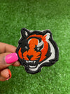 Embroidered Bengal Tiger iron-on patch featuring a detailed and vibrant design of a majestic Bengal Tigers face. Perfect for jackets, backpacks, hats, and clothing. Embroidered iron-on patch featuring the Bengals logo with bold colors and stitching. Cincinnati