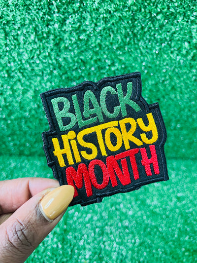 An image of custom Black History Month patches featuring vibrant, bold designs that celebrate Black culture, heritage, and achievements. The patches include empowering phrases, colorful Afrocentric patterns, and symbols of unity and pride. Each patch is intricately embroidered, showcasing high-quality craftsmanship and thoughtful design, perfect for honoring Black History Month on clothing, bags, or accessories.