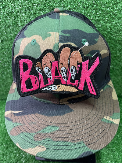 Embroidered iron-on patch featuring the word Black held by a hand with stylish-black and white nails. The letters Black are embroidered in bold pink stitching.