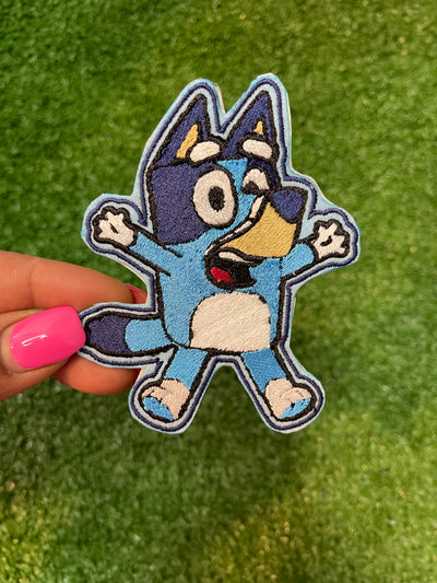 Bluey cartoon character iron-on patch with vibrant colors and playful design.