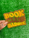 Bold and trendy iron-on patch featuring the phrase 'Book Club Baddie' in stylish lettering. Perfect for book lovers, this high-quality embroidered patch showcases vibrant colors and intricate stitching, ideal for adding a literary flair to jackets, backpacks, hats, and other clothing items.