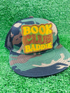 Bold and trendy iron-on patch featuring the phrase 'Book Club Baddie' in stylish lettering. Perfect for book lovers, this high-quality embroidered patch showcases vibrant colors and intricate stitching, ideal for adding a literary flair to jackets, backpacks, hats, and other clothing items.