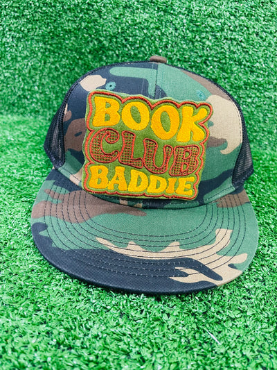 Bold and trendy iron-on patch featuring the phrase 'Book Club Baddie' in stylish lettering. Perfect for book lovers, this high-quality embroidered patch showcases vibrant colors and intricate stitching, ideal for adding a literary flair to jackets, backpacks, hats, and other clothing items.