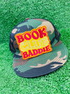 Bold and trendy iron-on patch featuring the phrase 'Book Club Baddie' in stylish lettering. Perfect for book lovers, this high-quality embroidered patch showcases vibrant colors and intricate stitching, ideal for adding a literary flair to jackets, backpacks, hats, and other clothing items.