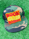 Bold and trendy iron-on patch featuring the phrase 'Book Club Baddie' in stylish lettering. Perfect for book lovers, this high-quality embroidered patch showcases vibrant colors and intricate stitching, ideal for adding a literary flair to jackets, backpacks, hats, and other clothing items.