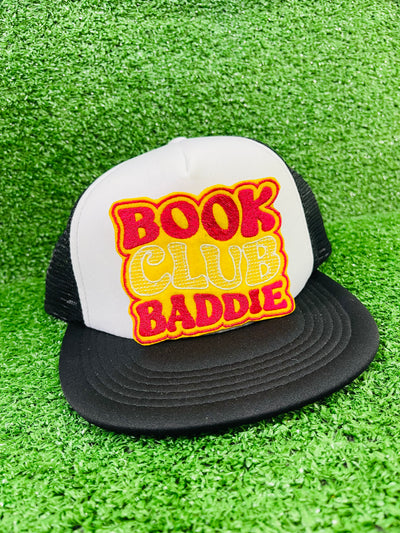 Bold and trendy iron-on patch featuring the phrase 'Book Club Baddie' in stylish lettering. Perfect for book lovers, this high-quality embroidered patch showcases vibrant colors and intricate stitching, ideal for adding a literary flair to jackets, backpacks, hats, and other clothing items.