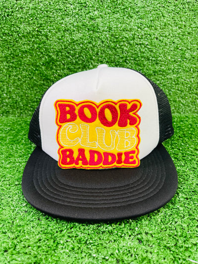 Bold and trendy iron-on patch featuring the phrase 'Book Club Baddie' in stylish lettering. Perfect for book lovers, this high-quality embroidered patch showcases vibrant colors and intricate stitching, ideal for adding a literary flair to jackets, backpacks, hats, and other clothing items.