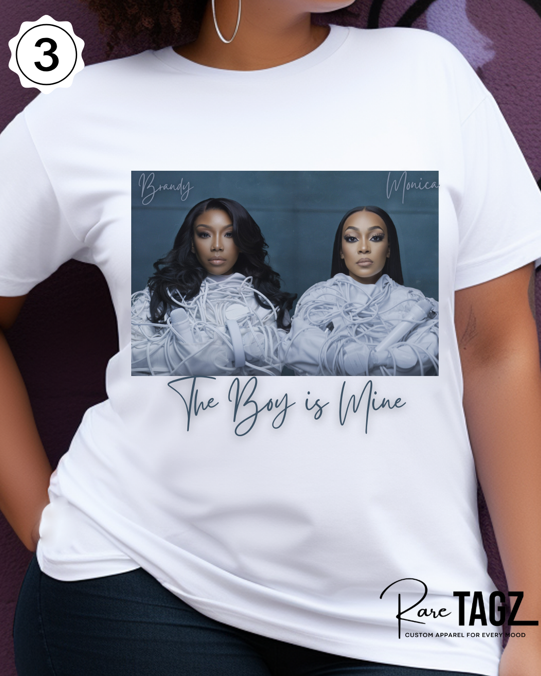 Woman wearing a white t-shirt with graphic design of Brandy and Monica and text that reads The Boy is Mine.  Promoting the Boy is Mine Tour.