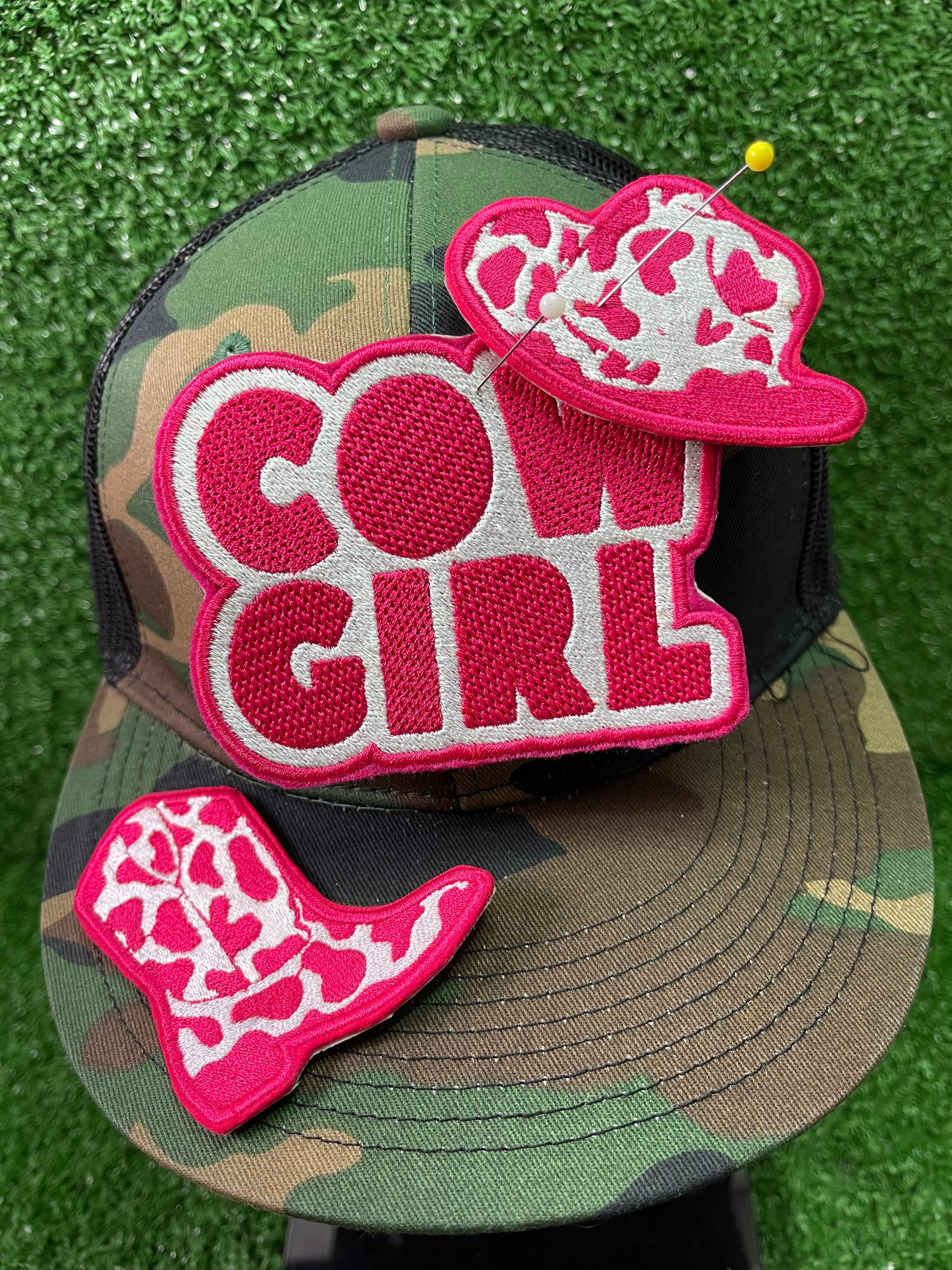 Set of three cow-girl themed iron-on patches: a detailed pink and white cowboy hat, a pink cowboy boot, and a patch with the words COWGIRL in bold pink letters on a white background.