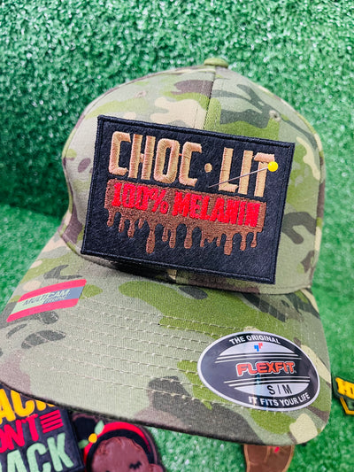 Embroidered patch reading Choc-Lit 100% Melanin with dripping chocolate effect, in bold black, red, and brown tones.