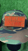 Embroidered Cleveland Browns iron-on patch in bold, orange letters on a brown background.