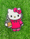 A set of four embroidered patches displayed on bright green grass. The set includes a white kitty wearing a pink hoodie, and holding an iced coffee, a pink bow, a green flower with a yellow center, and a pink flower with a yellow center. The patches are digitized and embroidered with high-quality stitching.