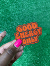 Good Energy patch with bold embroidered letters on a brown background.