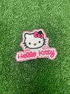 A close up of a Hello Kitty patch featuring the character's signature bow and face, ideal for adding a cute and playful touch to clothing or accessories.