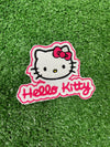 A close up of a Hello Kitty patch featuring the character's signature bow and face, ideal for adding a cute and playful touch to clothing or accessories.