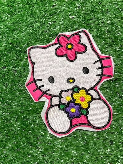 Hello Kitty holding an arrangement of colorful flowers on a patch. Perfect for personalizing jackets, bags, and trucker hats.