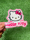 A close up of a Hello Kitty patch featuring the character's signature bow and face, ideal for adding a cute and playful touch to clothing or accessories.