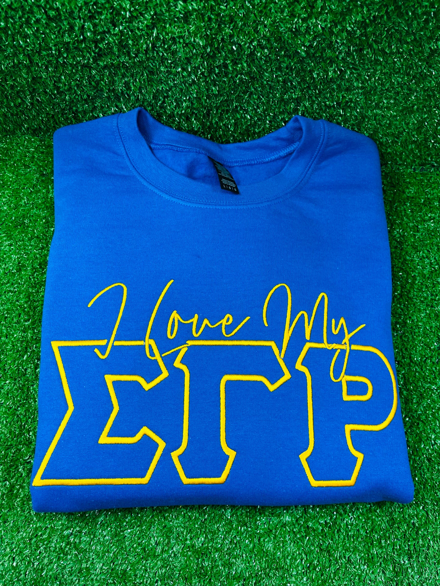 Blue sweatshirt with yellow/gold textz  'I love my Sigma Gamma Rho'. Embroidery sweatshirt